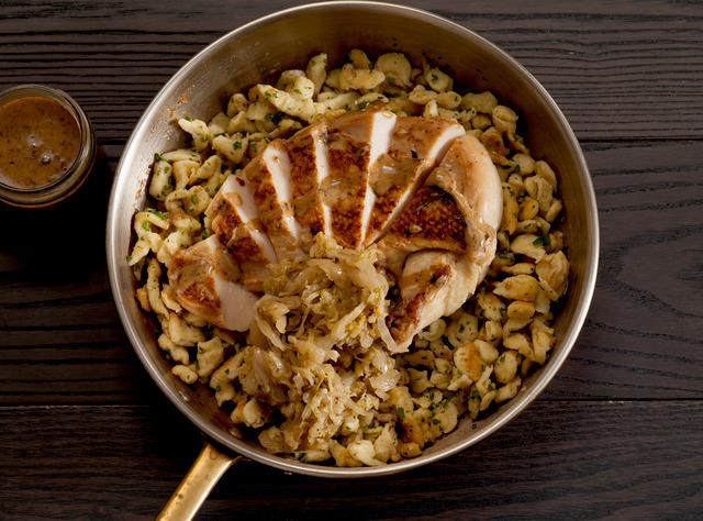 A Mediterranean plate catered by Lish with spiced chicken, rice, pita, salad, and sauce arranged for an office lunch.